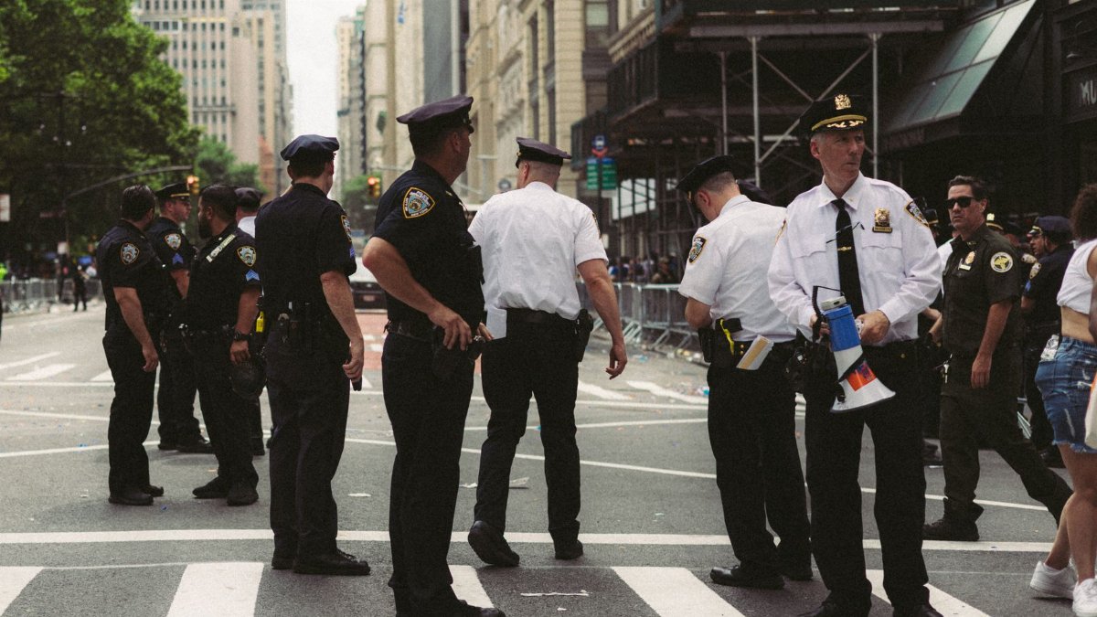 Police officers ensuring public safety at a city street during an urban event or parade.