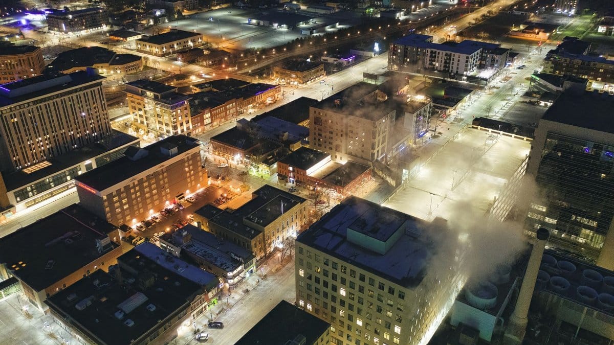 Stunning aerial view of downtown Rochester, MN, illuminated at night with city lights and streets in view.