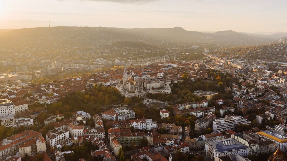 Breathtaking aerial view of Budapest, Hungary during sunset, highlighting the city's architecture and landscape.