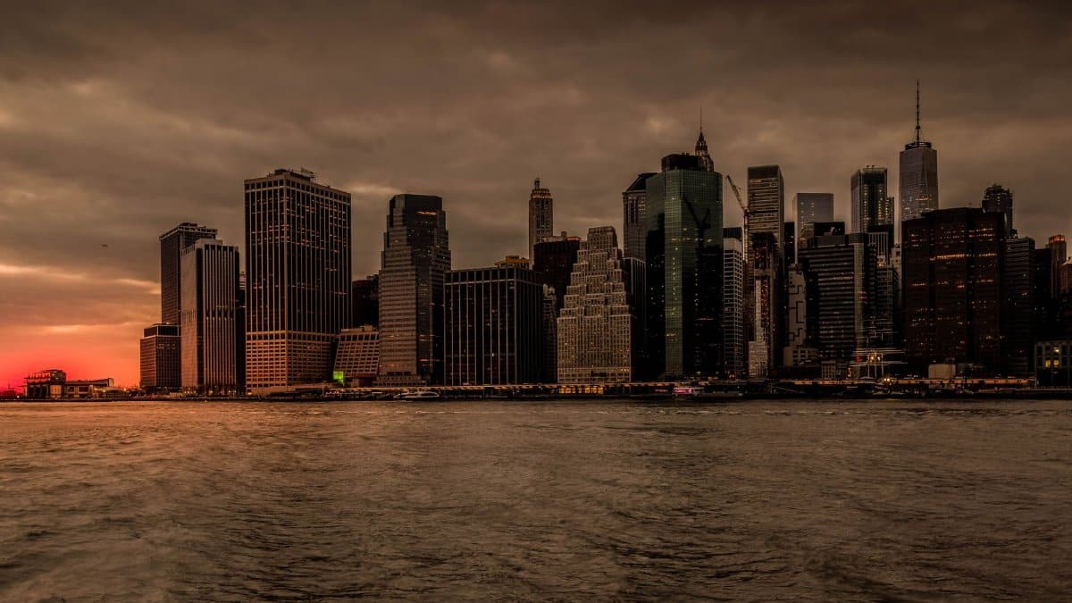 Captivating New York City skyline with a dramatic sunset backdrop over the water.