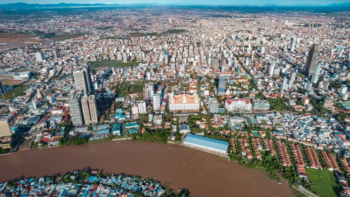 Explore the bustling urban scenery of Phnom Penh from above, showcasing its vibrant architecture and city life.