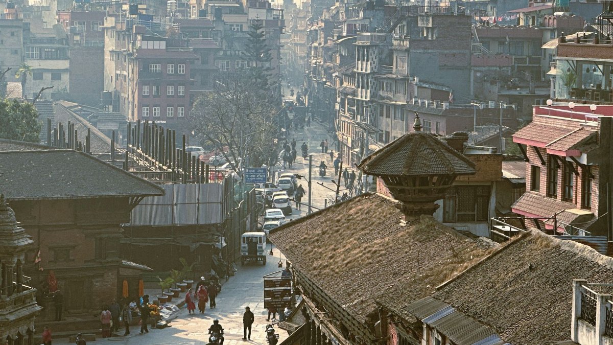 Busy street in Lalitpur, Nepal showcasing traditional architecture and vibrant city life.