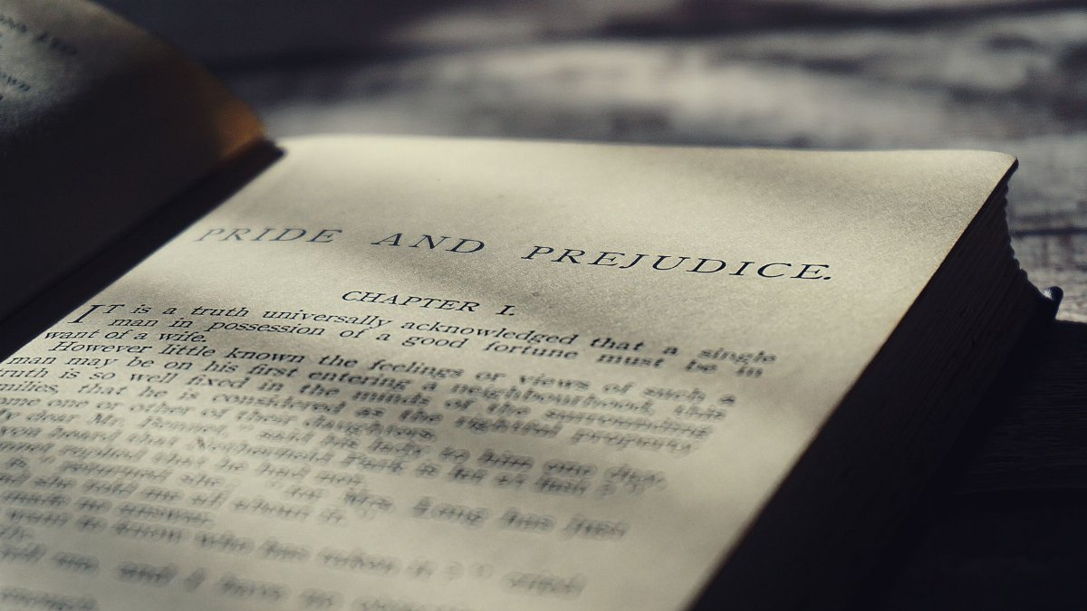 Close-up view of an open vintage page from Pride and Prejudice in warm sunlight.