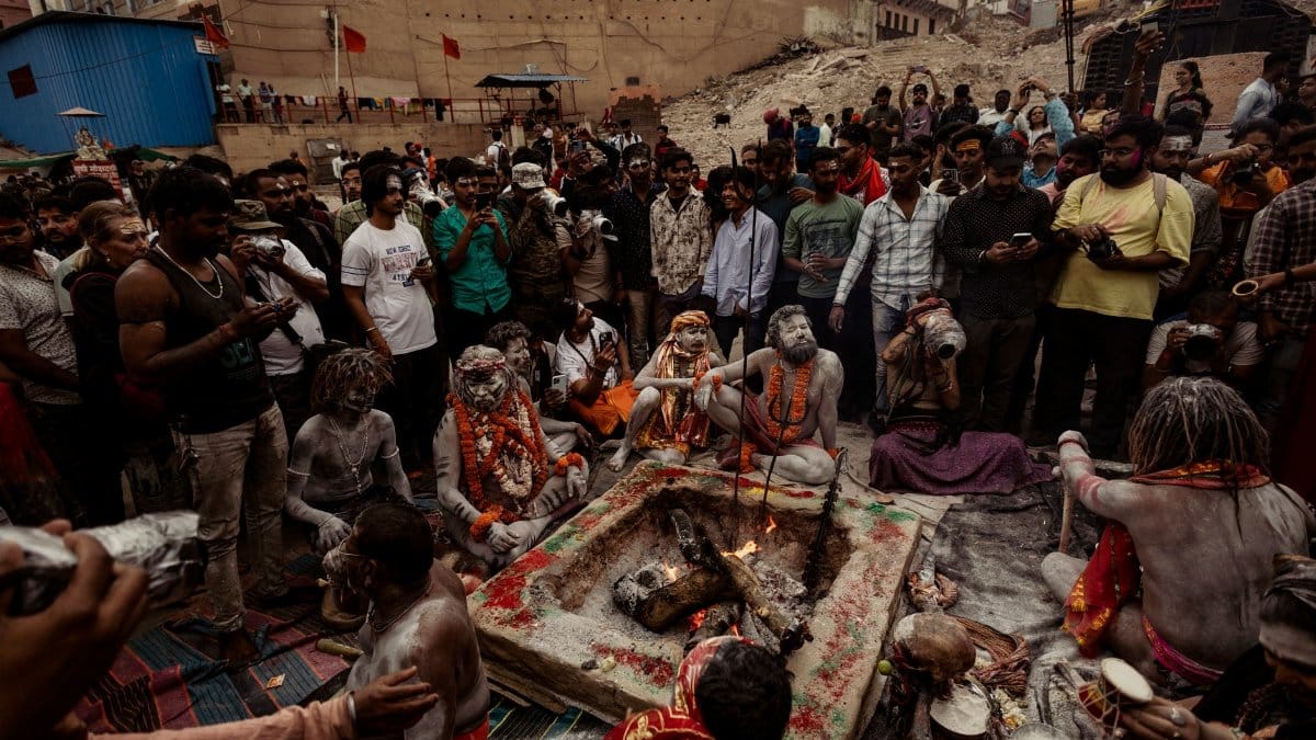 A group of people participates in a traditional ritual around a sacred fire, evoking cultural and spiritual significance.