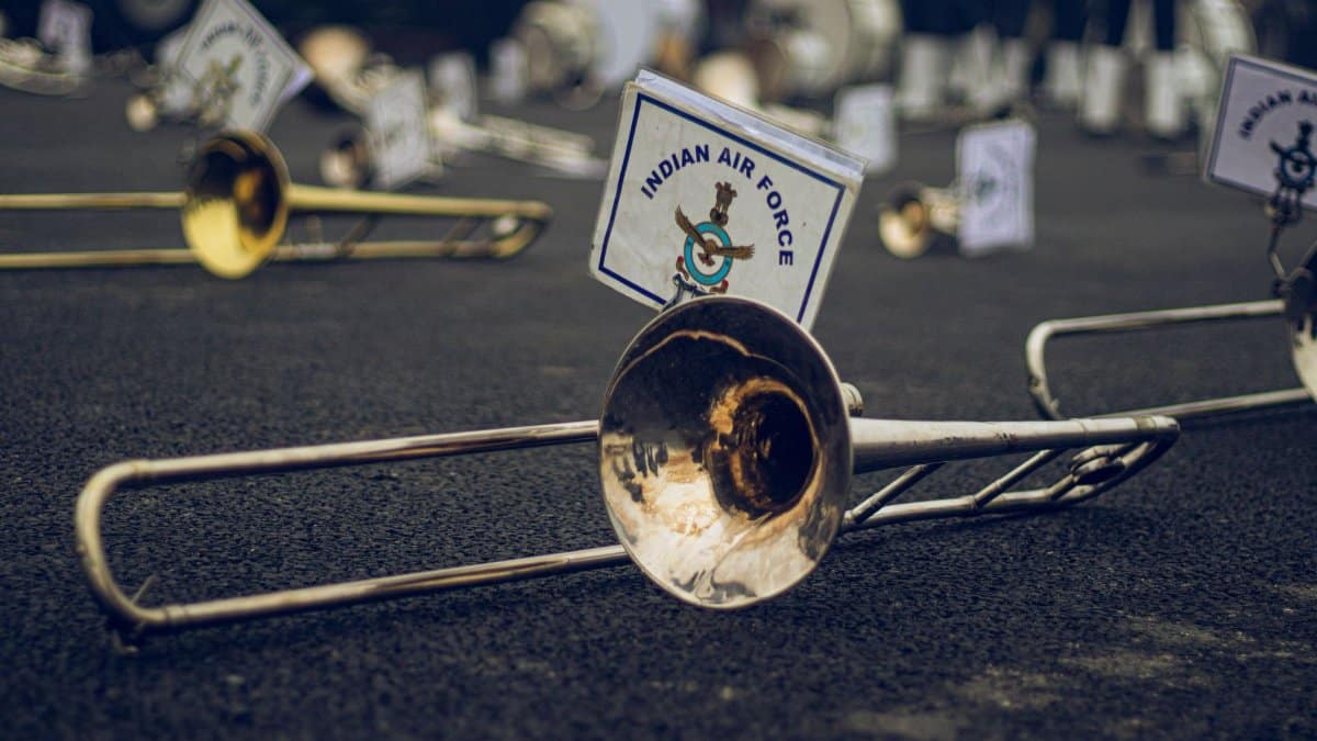 Close-up of Indian Air Force band instruments laid on asphalt during a parade.