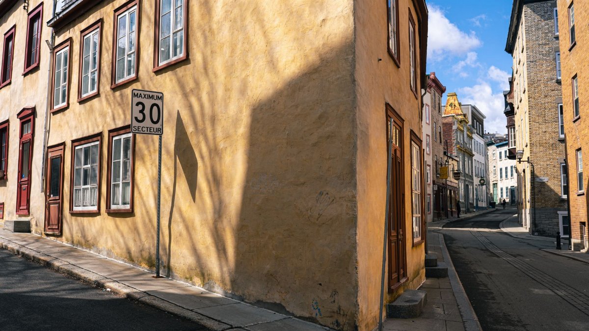 Quaint street with colorful historic buildings in warm daylight, perfect for travel imagery.