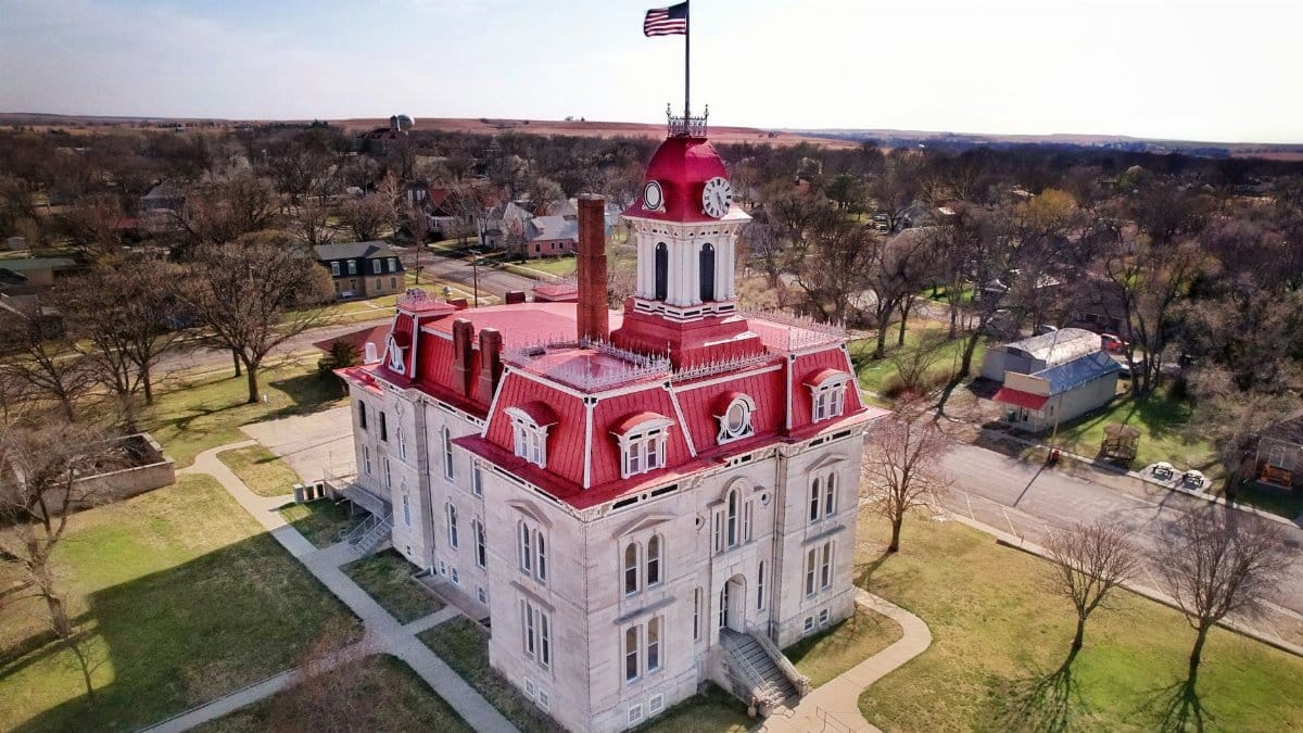Aerial shot of the historic Chase County Courthouse in Cottonwood Falls, KS, capturing its distinctive architecture.