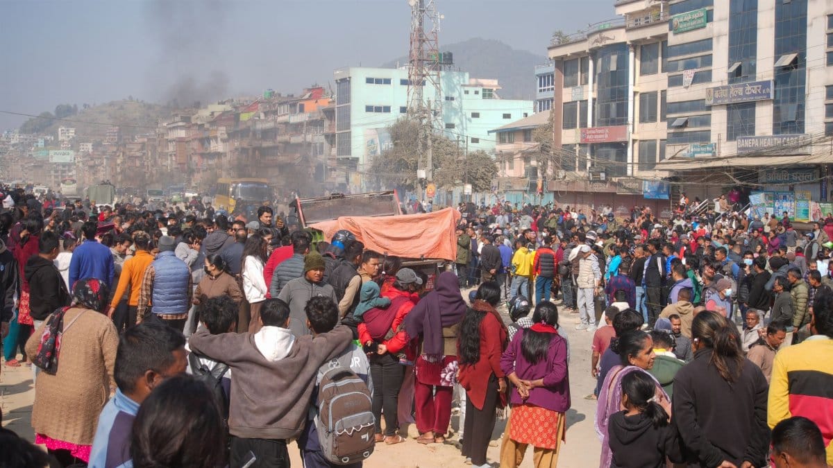 A bustling street with a large crowd gathered in an urban area, showcasing vibrant community life.