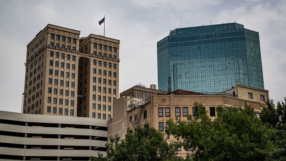 A cityscape showcasing contrasting architectural styles in downtown Fort Worth.