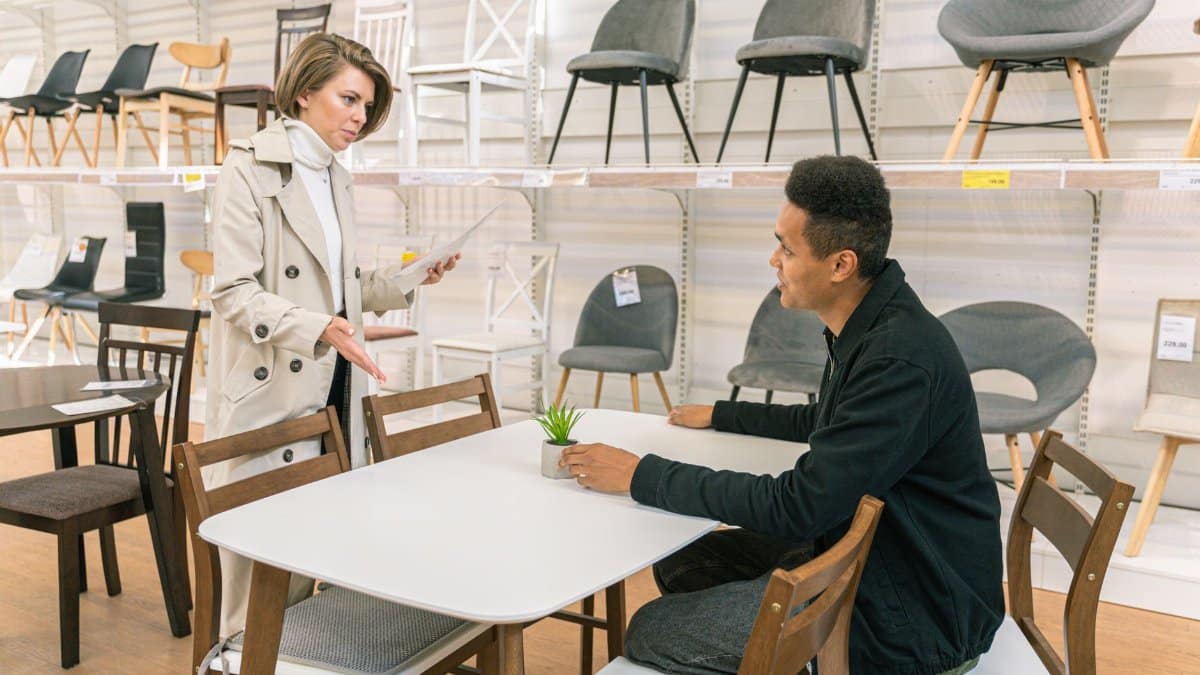 A customer discussing options with a salesperson in a furniture store showroom.