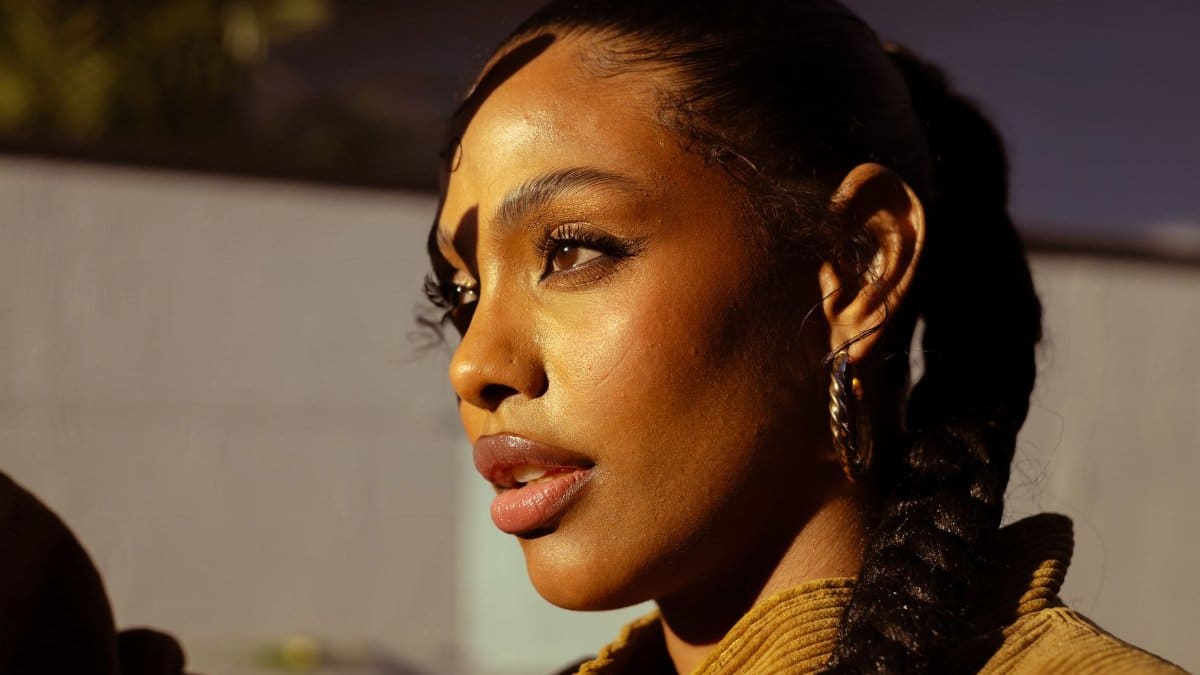 Close-up of a woman with braided hair, captured during sunset in São Paulo, Brasil.