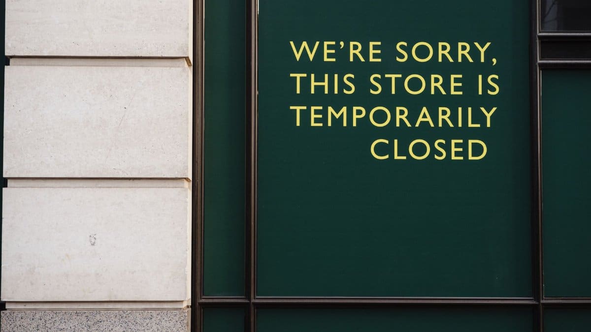 A photo of a store facade with a sign indicating temporary closure due to unforeseen circumstances.
