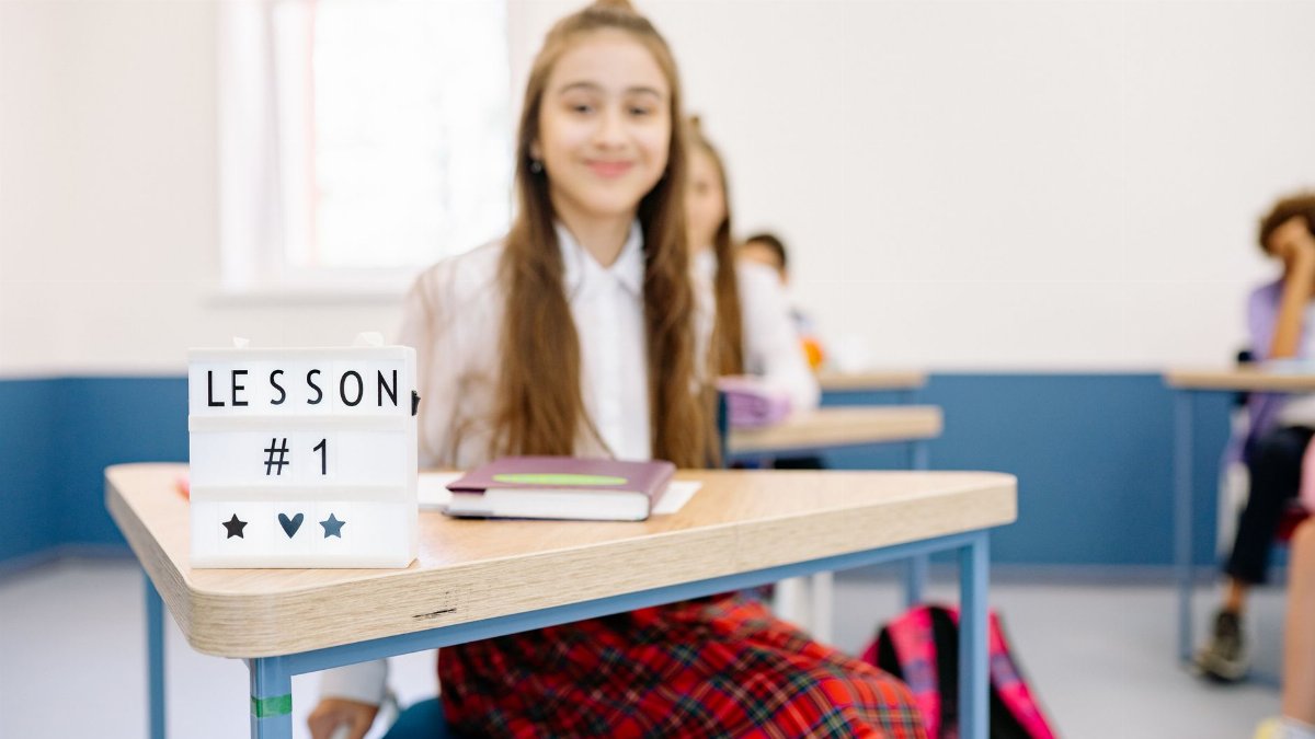 A classroom setting with a focus on learning and students engaging in lesson number one.