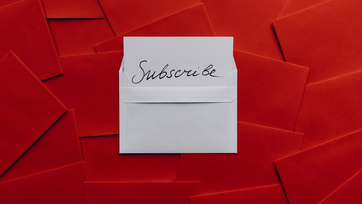 A collection of red envelopes with a central white envelope containing a subscribe card. Perfect for marketing themes.