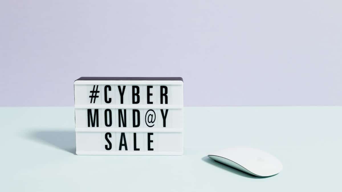Minimalist setup featuring a Cyber Monday sale sign and computer mouse, perfect for online shopping themes.