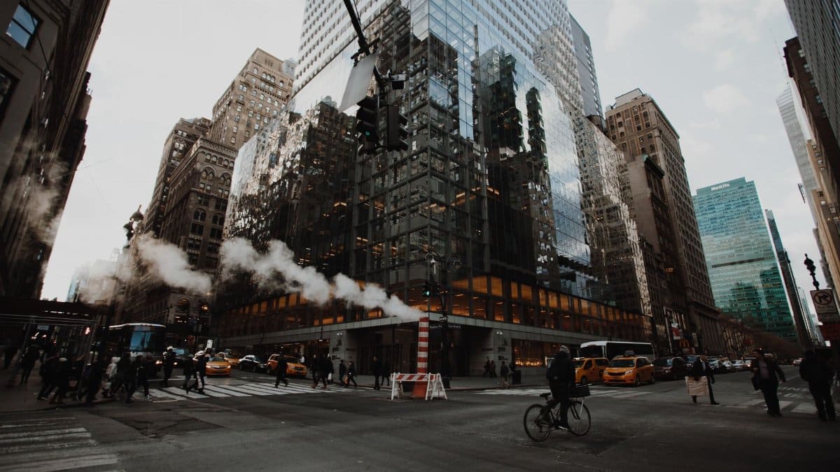 View of a busy intersection in New York City with skyscrapers and traffic.