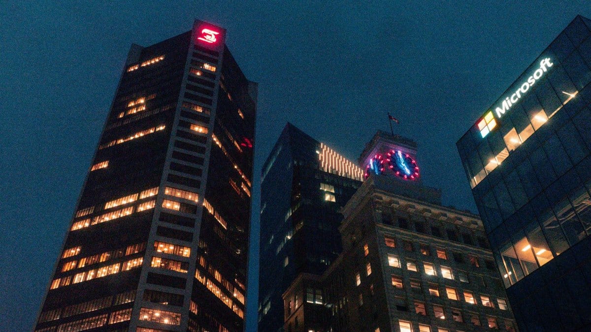 Vancouver skyline featuring illuminated skyscrapers at night with iconic architecture. Captured in British Columbia, Canada.