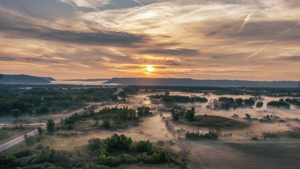 A breathtaking sunrise over misty fields in Wabasha, Minnesota, captures nature's serene beauty.