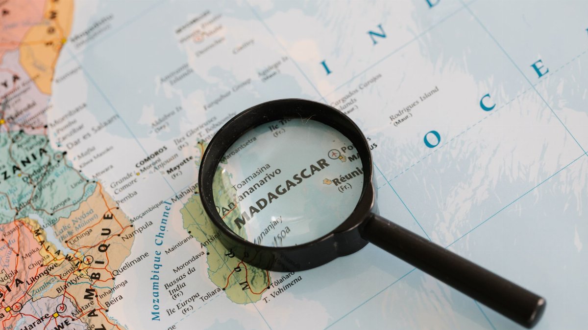 Close-up of Madagascar on a map with a magnifying glass highlighting the area.