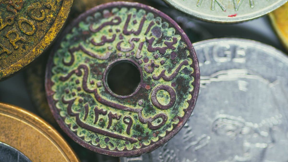 Macro photography of an antique Tunisian coin with Arabic script and intricate details.
