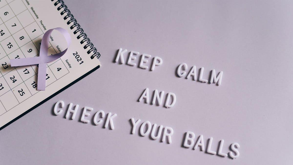 Calendar with quote promoting testicular cancer awareness and a purple ribbon.