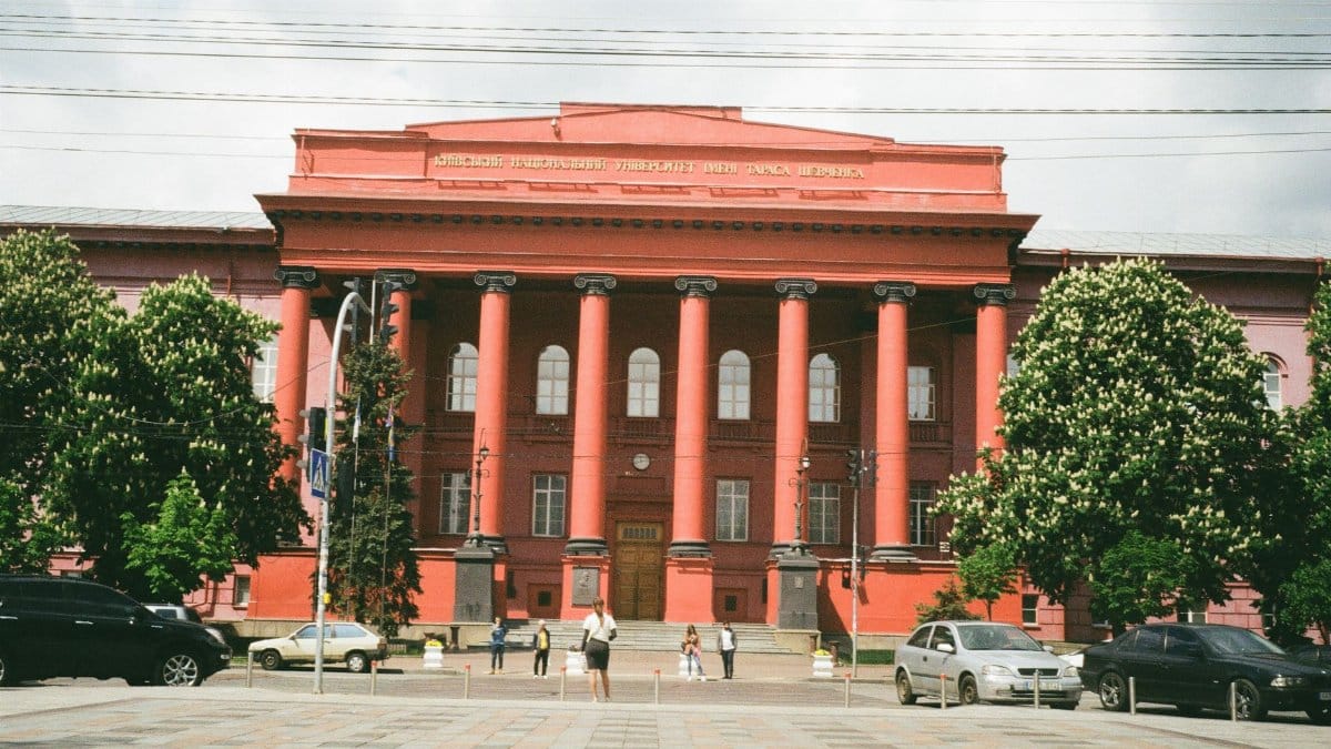 Red facade university building with columns, located in Kyiv, Ukraine.