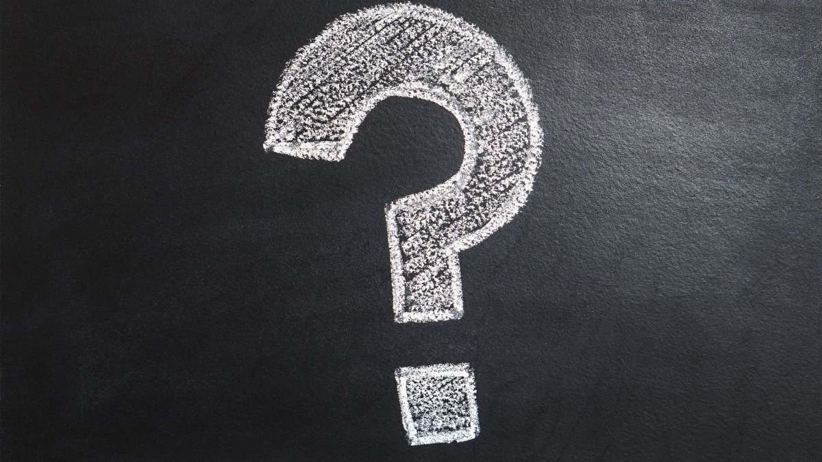 A conceptual image featuring a question mark drawn on a chalkboard, ideal for problem-solving contexts.