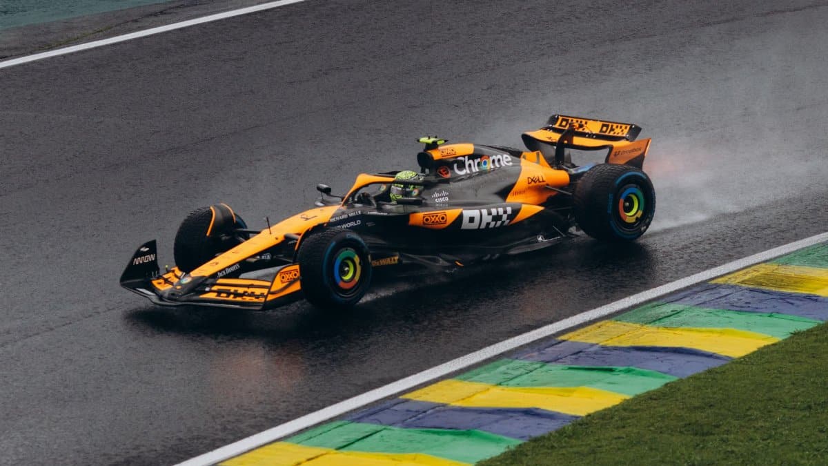 A vibrant Formula One car speeding on a wet track, showcasing dynamic motorsport action.