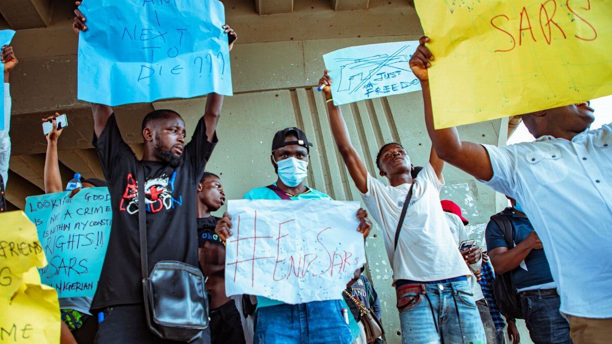 A group of protesters in Nigeria holding signs during an End SARS rally.