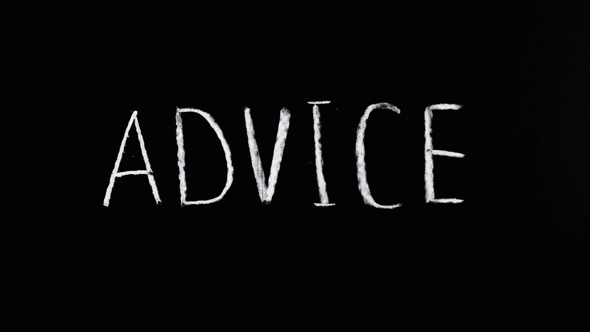 Inspirational word 'Advice' written in white chalk on blackboard.