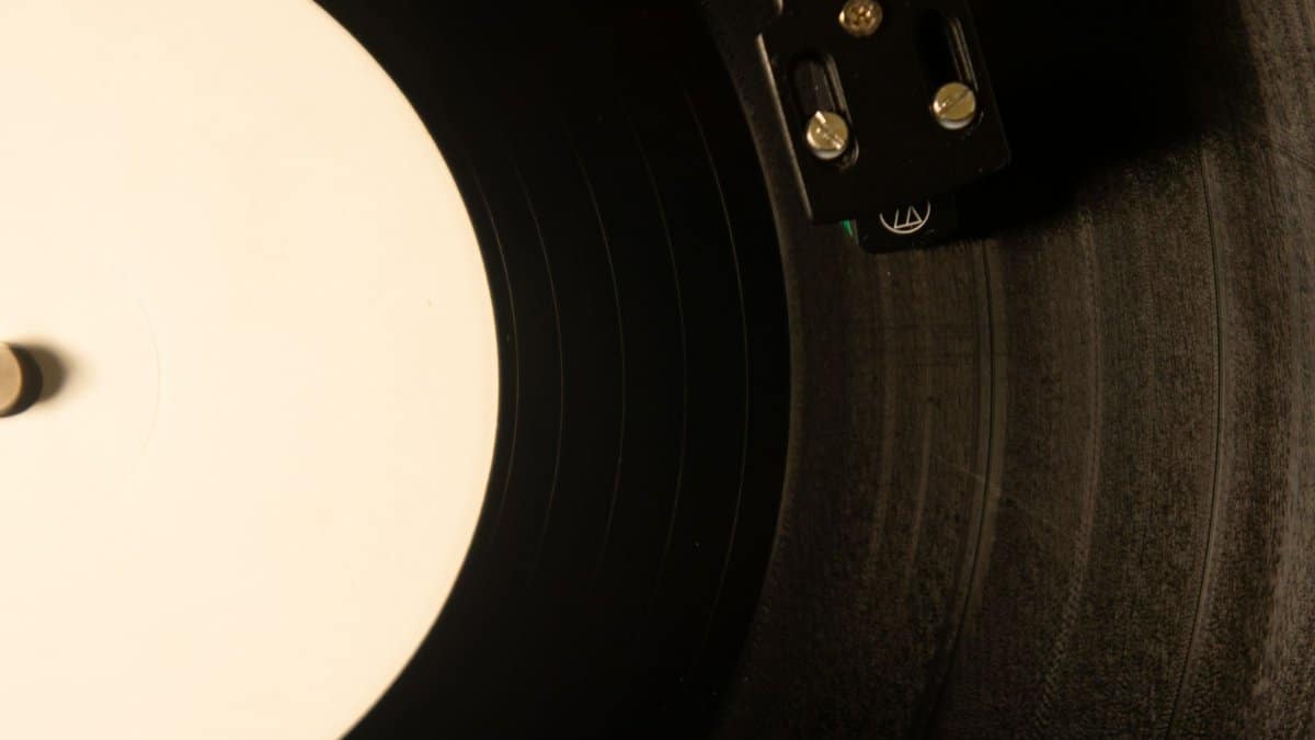 Vintage vinyl record player with close-up of needle on black gramophone, creating a nostalgic music vibe.