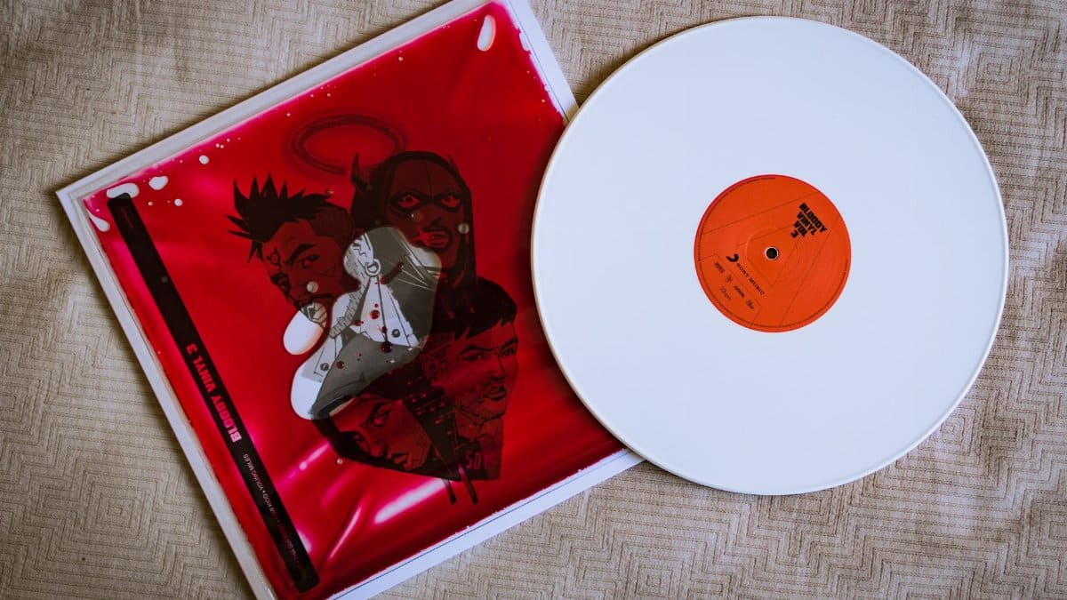 Aesthetic white vinyl record with red cover featuring abstract artwork, perfect for music lovers.