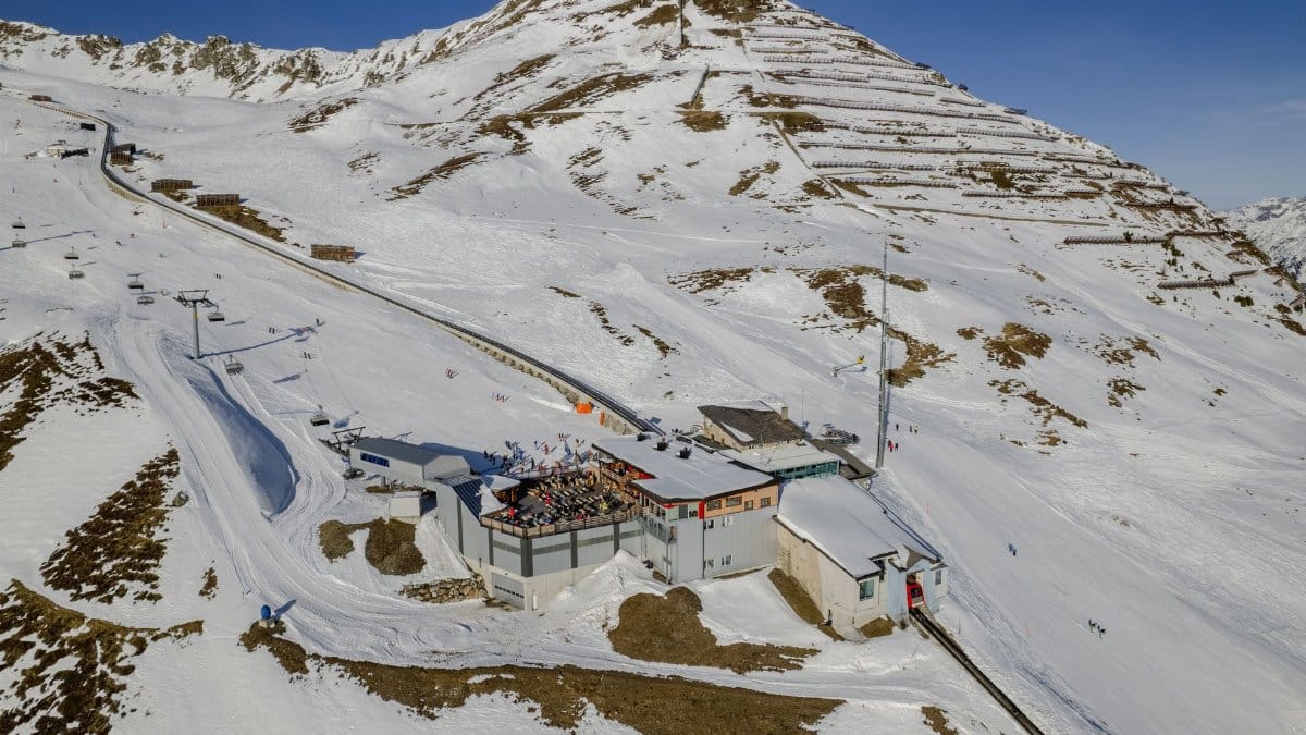 Snow-covered ski resort in Klosters, Switzerland with mountain backdrop.