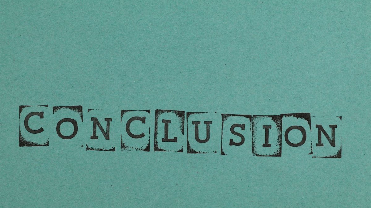Conclusion word stamped on textured blue paper with block letters, conveying finality.