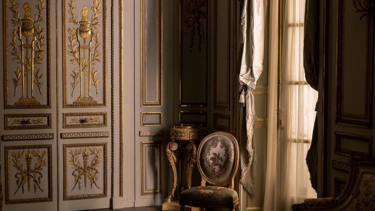 Luxurious interior featuring ornate gold design and classic furniture in a regal setting.
