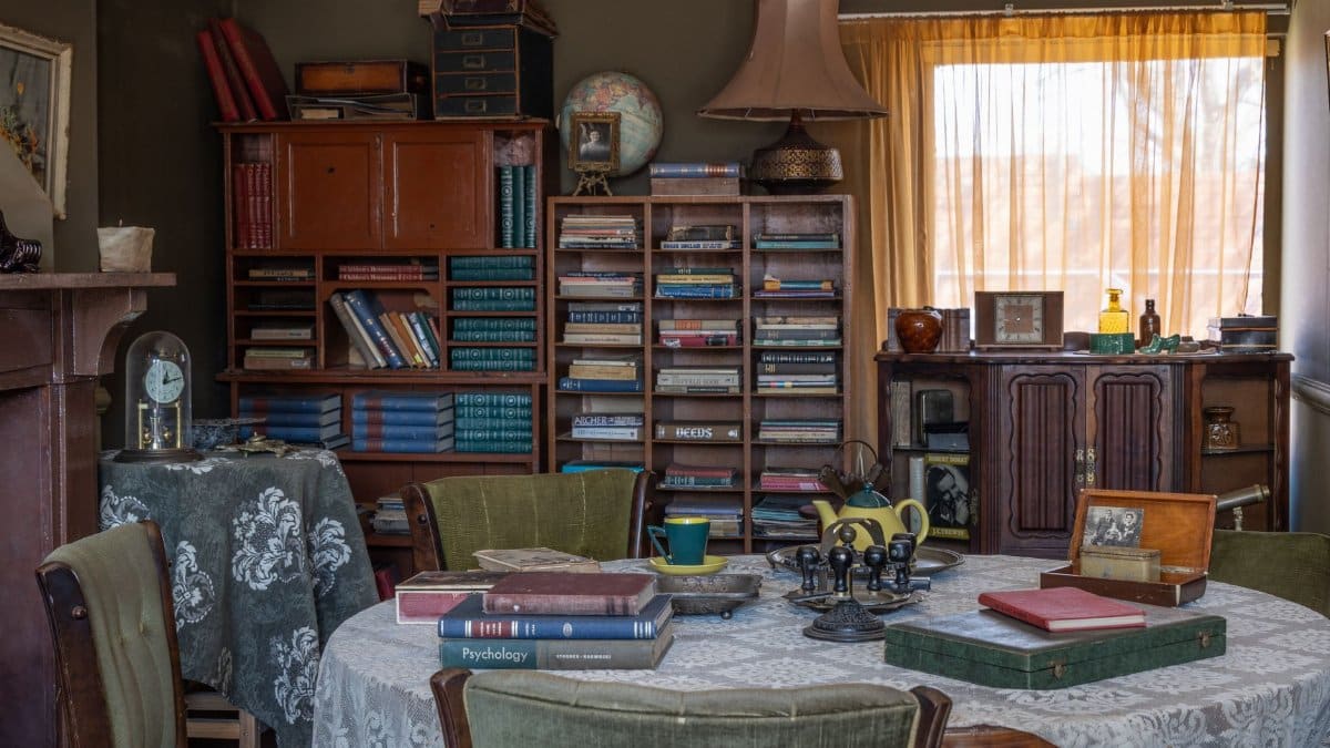 Cozy vintage room filled with antique books, furniture, and decor creating a nostalgic atmosphere.