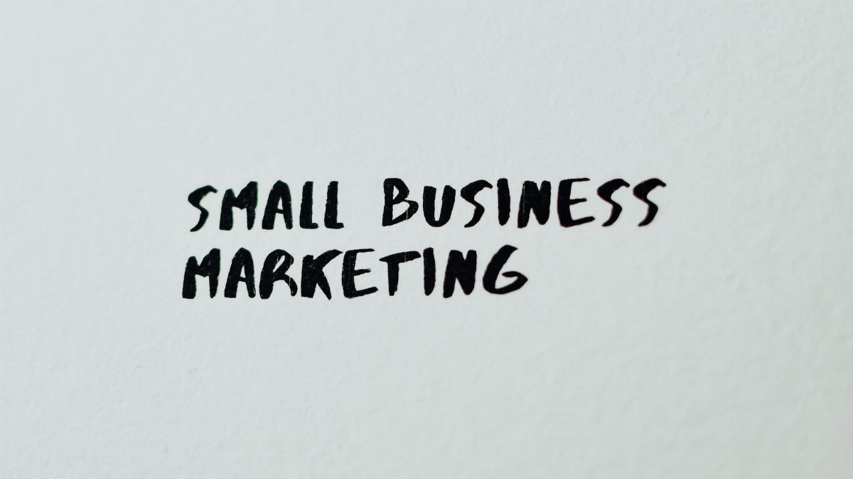 Text 'Small Business Marketing' written on white paper for creative use.