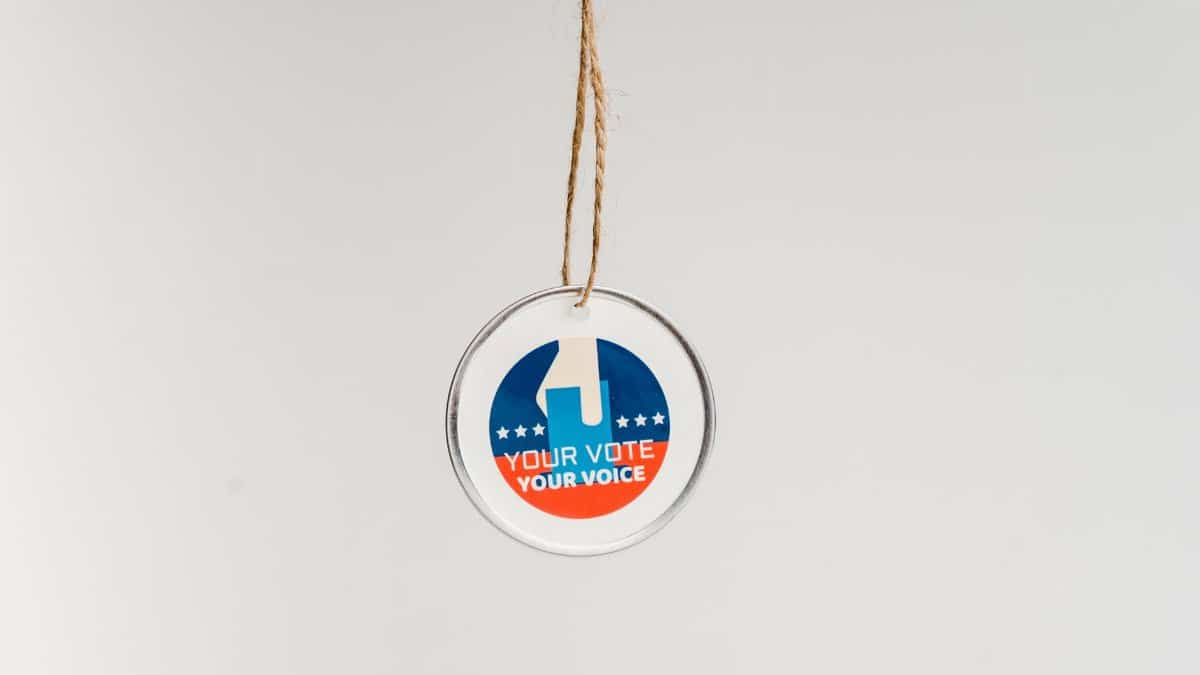 Close-up of a hanging ornament promoting voting with 'Your Vote Your Voice' text.