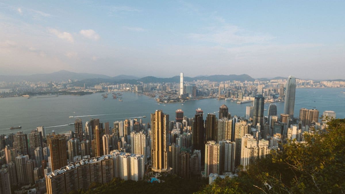 Panoramic view of Hong Kong skyline from Victoria Peak during daytime, showcasing urban architecture.