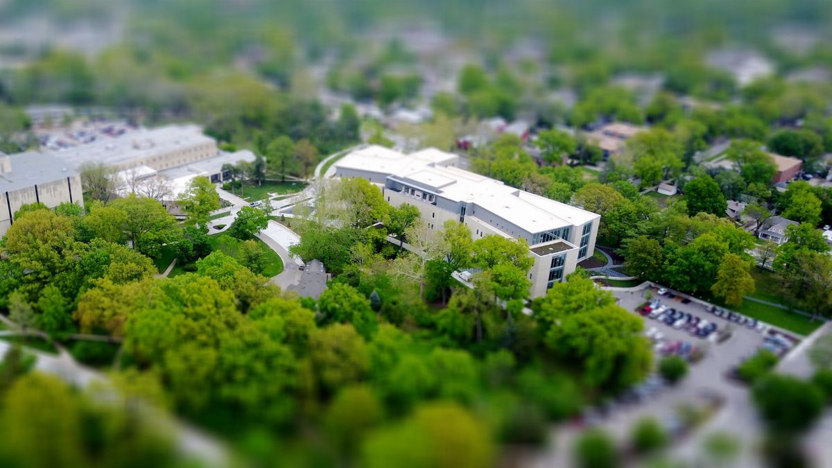 Aerial view of a modern campus building surrounded by greenery in Manhattan, KS.