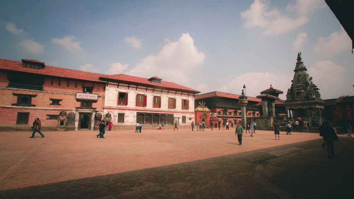 A captivating view of Patan Durbar Square with historic architecture and tourists exploring the area.