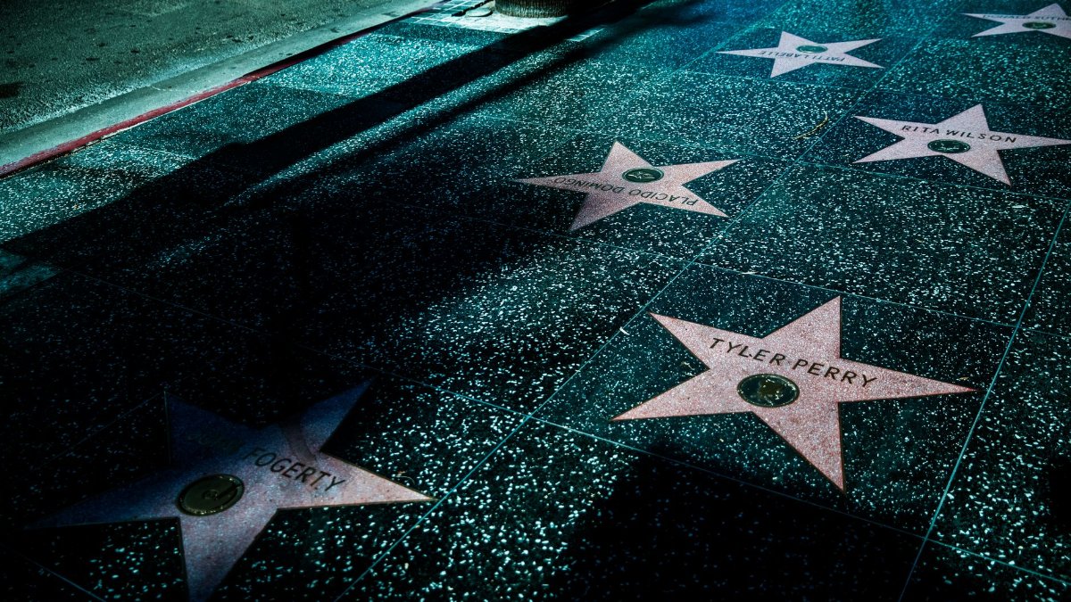 Night view of Hollywood Walk of Fame stars showcasing celebrity names and iconic design.