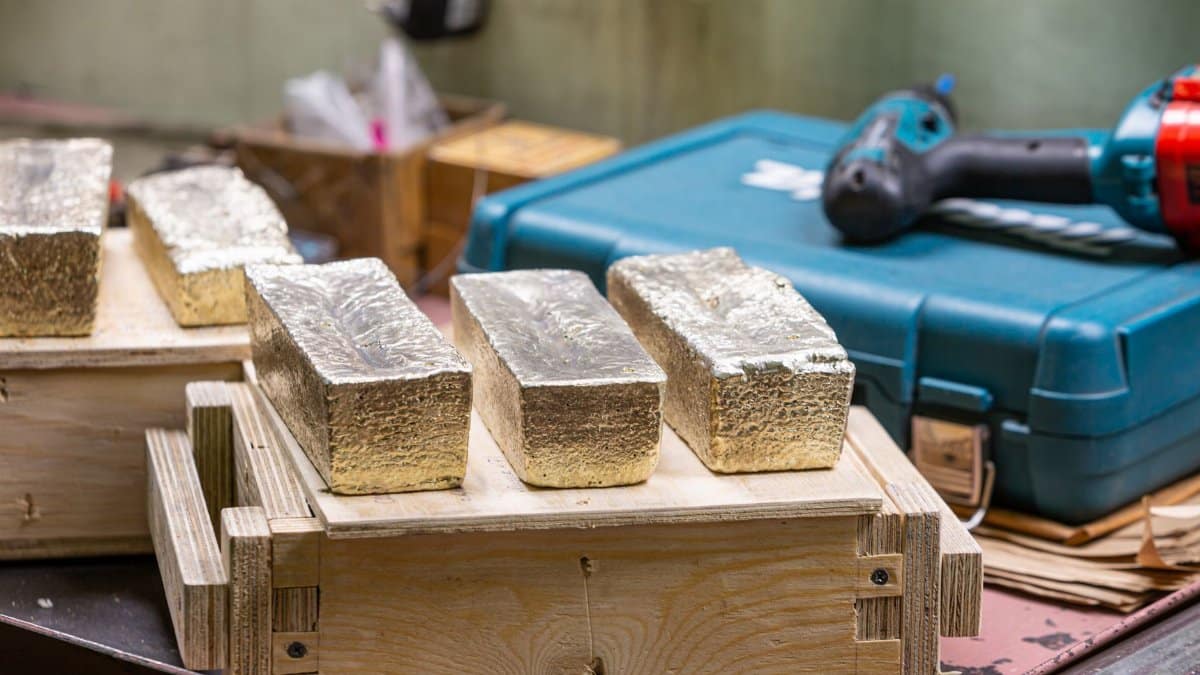 Gold bars in a workshop, highlighting metalwork and industrial themes.