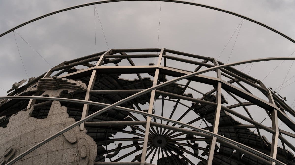 Detailed view of the Unisphere globe with overcast skies, showcasing intricate metal framework.