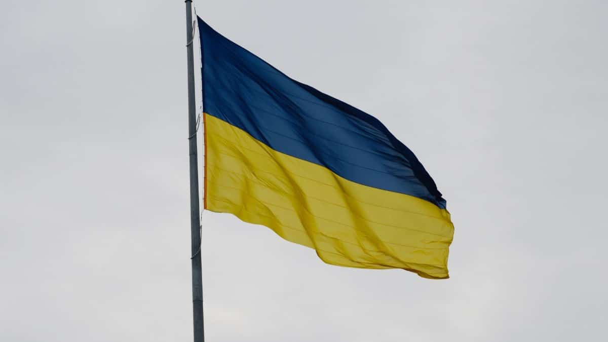 Ukrainian national flag waving against a cloudy sky, symbolizing national pride.