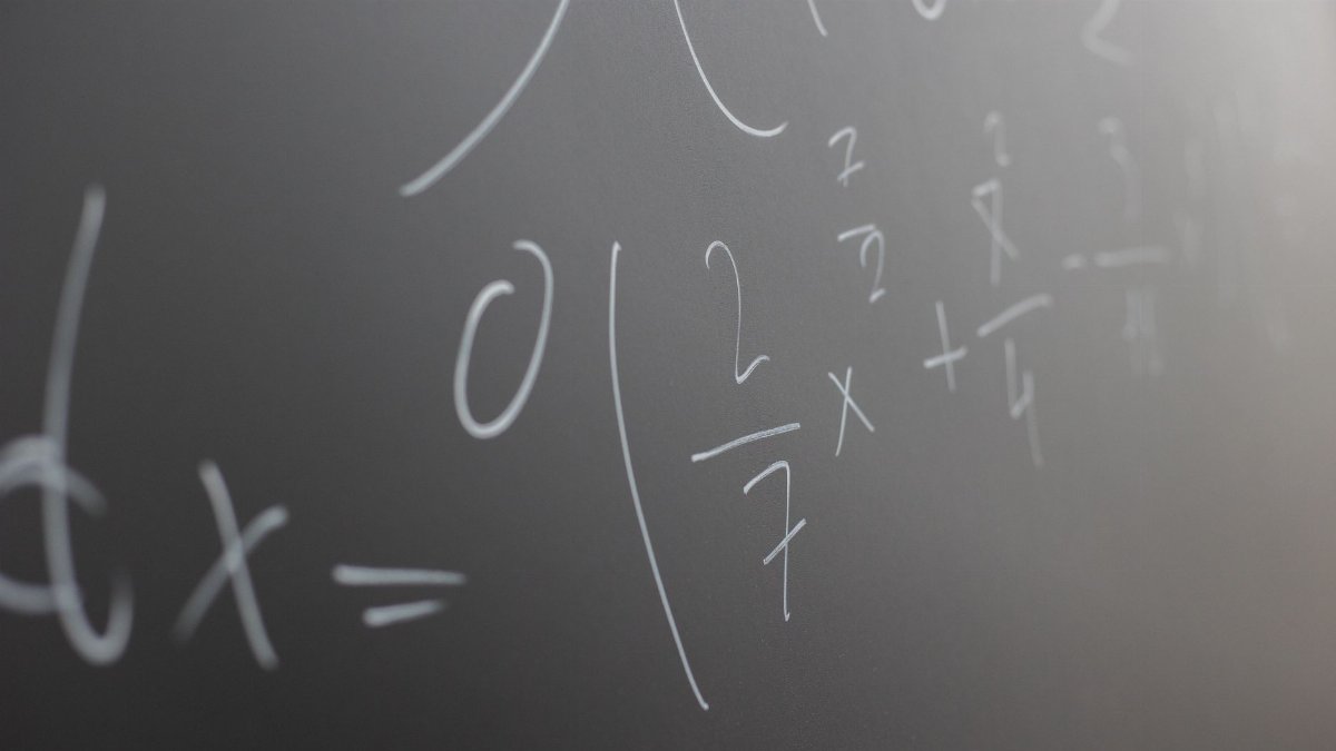 Blackboard with handwritten mathematical example for solve on lesson during studies in classroom of university