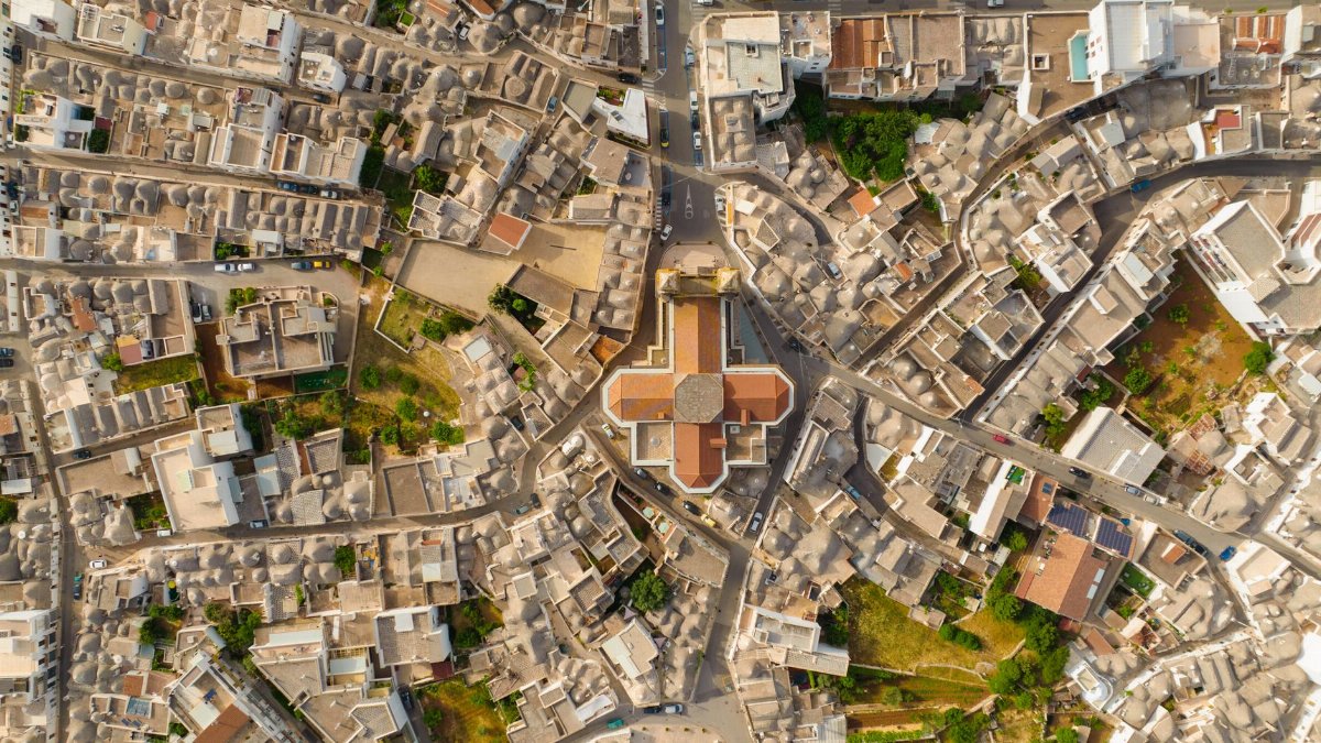 Drone shot capturing unique stone buildings of a historic town from above.