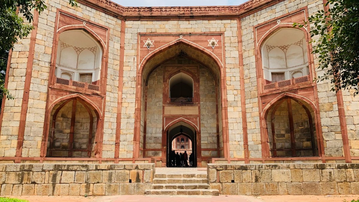 Exterior view of Bu Halima Gateway in India showcasing its architectural details and entrance steps.