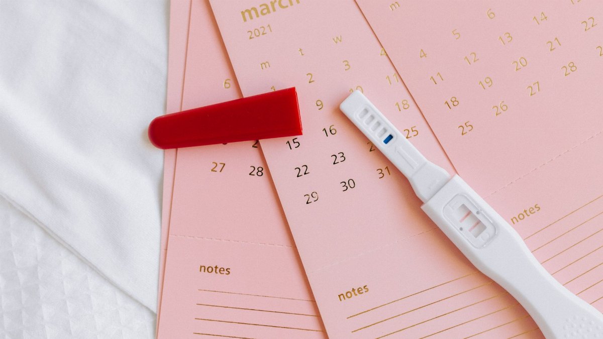 Close-up of a pregnancy test on March 2021 calendar, symbolizing expecting news.