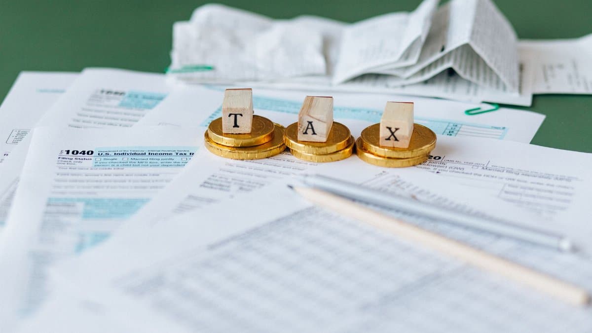 Close-up of tax forms, receipts, and coins symbolizing financial accounting and taxes.